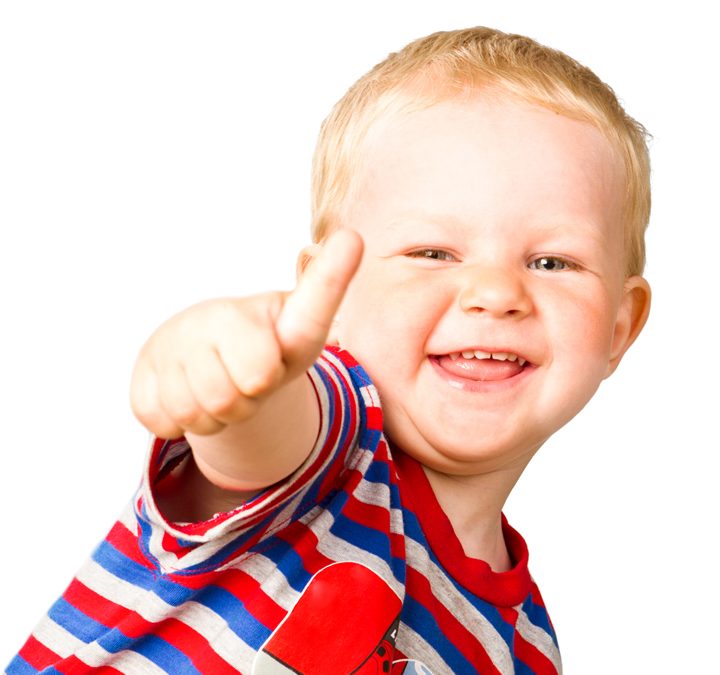 A happy boy is showing thumbs up; isolated on the white backgrou